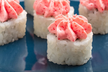 rolls on a blue plate. Serving Japanese food. Close-up