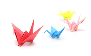 Origami paper birds teamwork on white