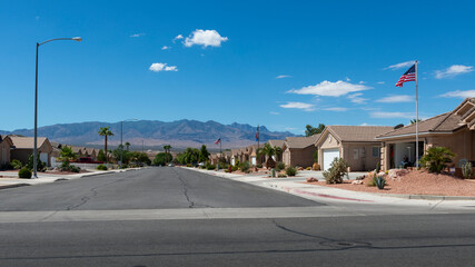 A row of recently build houses in a neighborhood in the State of Nevada, USA, with a mountain on...
