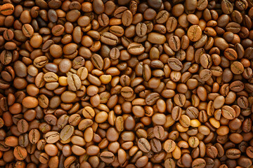 Brown background with natural coffee beans