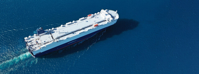 Aerial drone ultra wide photo of Large RoRo (Roll on-off) car transportation vessel cruising the...