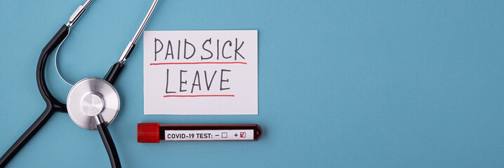 A positive covid test and a medical phonendoscope with the inscription paid sick leave on a blue background