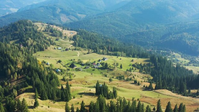 Aerial view from drone. Aerial view amazing over of the Carpathian Mountains or Carpathians with Beautiful summer landscape, sunny day, blue sky with white clouds