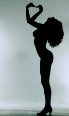 Obraz na płótnie Canvas Side View Of Silhouette Woman Standing Against Gray Background