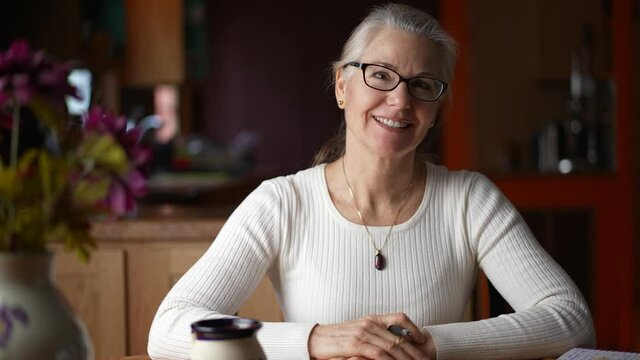 Portrait of remote business woman smiling looking at camera, webcam point of view in home. Happy teacher doing video chat.