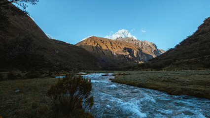 Fototapeta na wymiar River comes down from Chakrarahu mountain at start of trail to Lagoon 69, Peru.