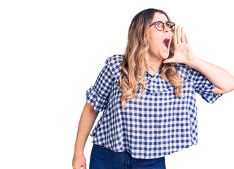 Young caucasian woman wearing casual clothes shouting and screaming loud to side with hand on mouth. communication concept.