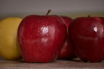 Bright red apples and a yellow one