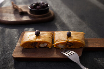 Typical dish of Peru known by the name of tamales, made with corn flour, chicken or pork, garlic, chili, black olives and egg.