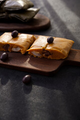 Typical dish of Peru known by the name of tamales, made with corn flour, chicken or pork, garlic, chili, black olives and egg.