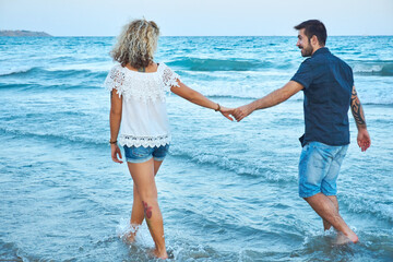 couple in love walking on sea shore - 406210155