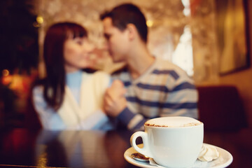 man and woman sitting in a cafe on a date. young couple in love