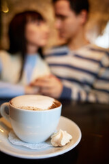 man and woman sitting in a cafe on a date. young couple in love