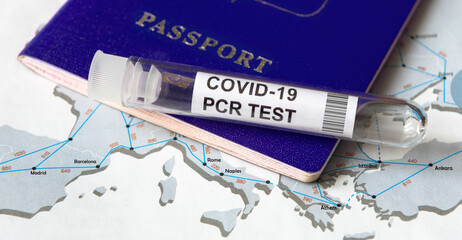COVID-19, travel and test concept, tube for coronavirus PCR testing and tourist passport on Europe...