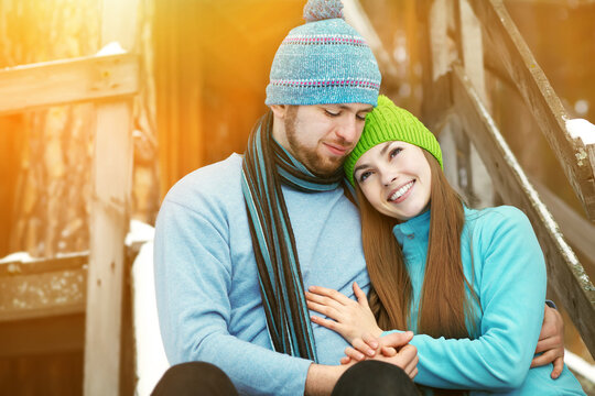 Young happy couple in love outdoors in the winter.