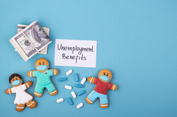 Money, medicine and a gingerbread family in masks inscription unemployment benefits