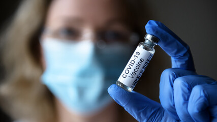 COVID-19 coronavirus vaccine in researcher hand close-up