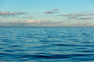 Turquoise water color against the sky. The Gulf of Finland. Baltic Sea. Ripples in the water. Sunny day. Background.