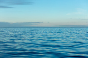 Turquoise water color against the sky. The Gulf of Finland. Baltic Sea. Ripples in the water. Sunny day. Background.