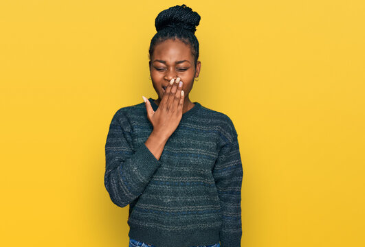 Young african american woman wearing casual clothes bored yawning tired covering mouth with hand. restless and sleepiness.