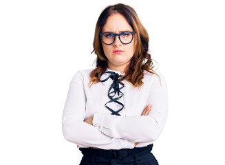 Young beautiful caucasian woman wearing business shirt and glasses skeptic and nervous,...