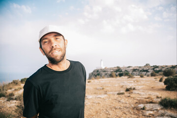 Young man smiling and looking at the camera.