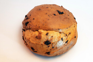 Roll sweet bread with raisins on a white background.