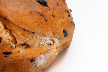 Roll sweet bread with raisins on a white background.