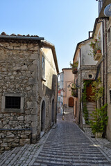 Fototapeta na wymiar A narrow street between the stone houses of Morcone, an old town in the province of Benevento, Italy. 