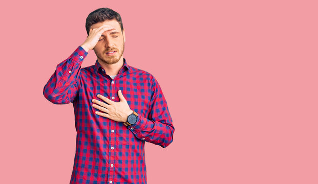 Handsome young man with bear wearing casual shirt touching forehead for illness and fever, flu and cold, virus sick