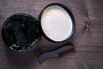 black cream and small comb for beard care