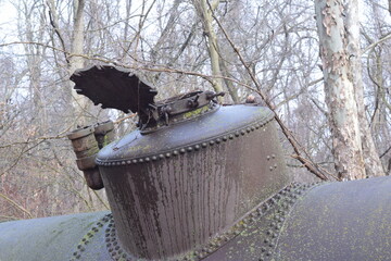 Abandoned industrial machinery empty tank with flap