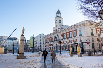 Puerta del Sol in Madrid covered by snow and cold from the storm Filomena. Great snowfall in Madrid. Snow storm.