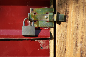 Padlock with metal latch. Locked door to utility room.