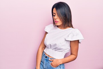 Young beautiful brunette woman wearing casual clothes standing over isolated pink background