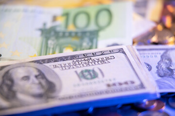 United States Dollar and Euro Banknotes. One Hundred Dollars and Euros on top of coins. Currency Exchange Rate