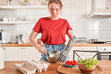 Woman chef with artificial limb preparing omelet