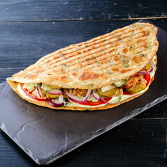 Kebab in a bun on woodboard, Shawarma sandwich gyro fresh pita bread chicken