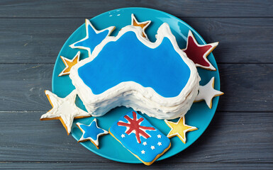 Happy Australia Day message greeting card - vanilla cream cake and patriotic sweets in a shape of the Australia	
