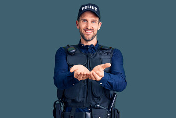 Young handsome man wearing police uniform smiling with hands palms together receiving or giving...