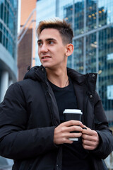 Handsome young man drinking morning coffee.
Everyday life in a big city.