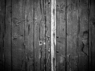 Detail of the old wooden door of a church. Black and white