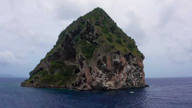 Flying around near to pirate abandoned volcanic mountain cliff in sea. Small volcanic cliff island.
du Diamant south at Fort-de-France, the main port of the Caribbean island of Martinique. Aerial