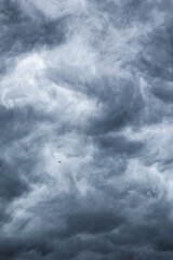 Dark cloudy sky before thunderstorm background. Storm heaven clouds in sky. Wide gloomy backdrop approaching storm.