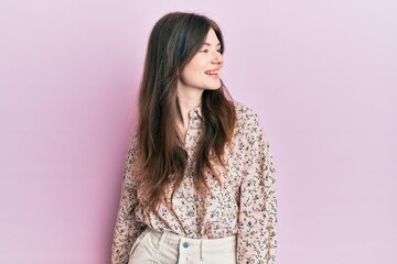 Fototapeta premium Young beautiful caucasian girl wearing elegant clothes looking away to side with smile on face, natural expression. laughing confident.