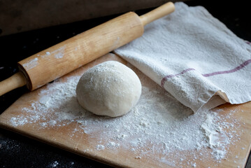 Fresh pasta dough on wooden cutting board