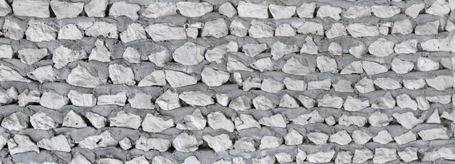 Rustic natural stone wall in panorama format