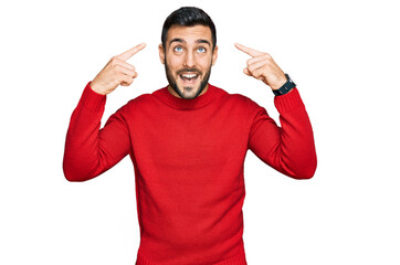 Young hispanic man wearing casual clothes smiling pointing to head with both hands finger, great idea or thought, good memory