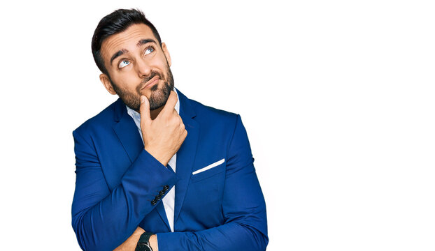Young hispanic man wearing business jacket thinking worried about a question, concerned and nervous with hand on chin