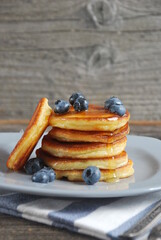 Pancakes with blueberries and honey on a plate